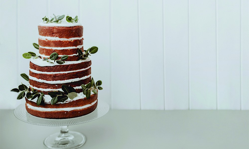 Wedding cake with fresh leaves